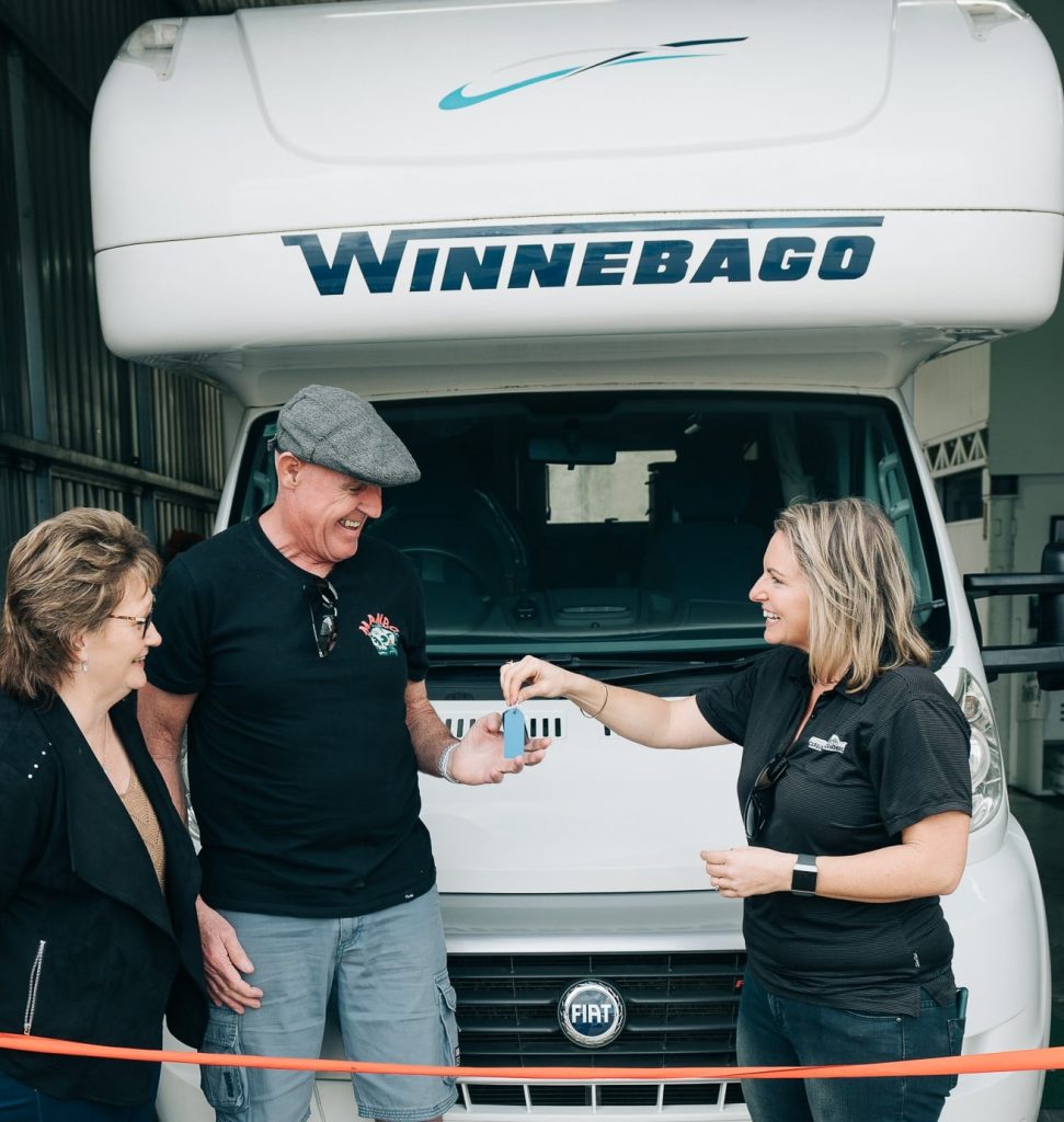 Customers standing in front of their new Winnebago
